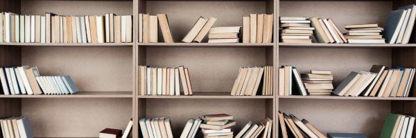 A book shelf with empty spaces